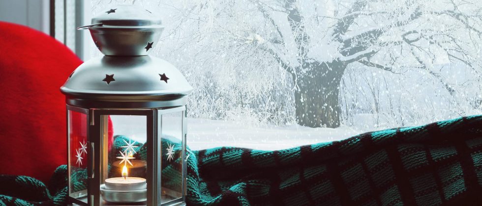 lantern next to a snowy window