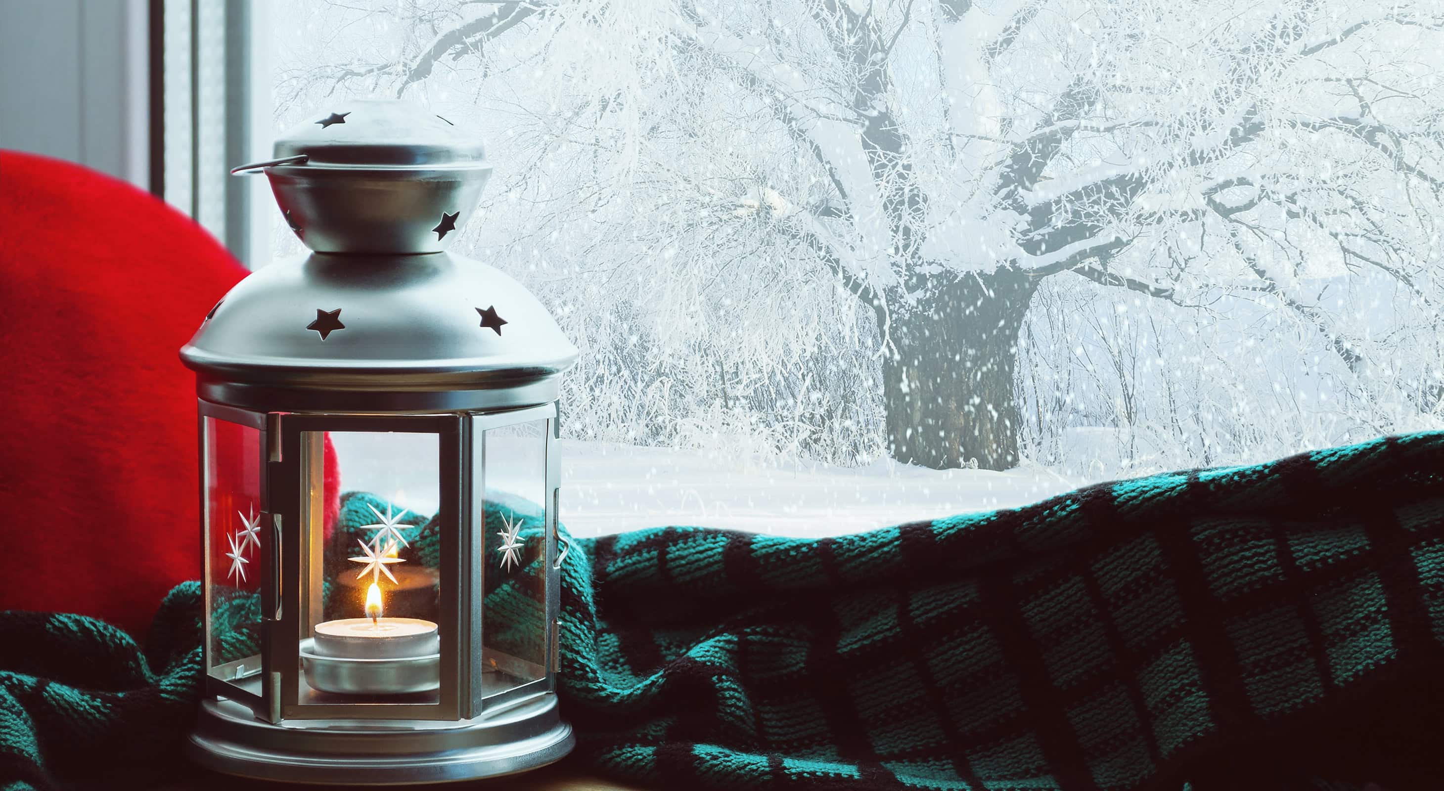 lantern next to a snowy window