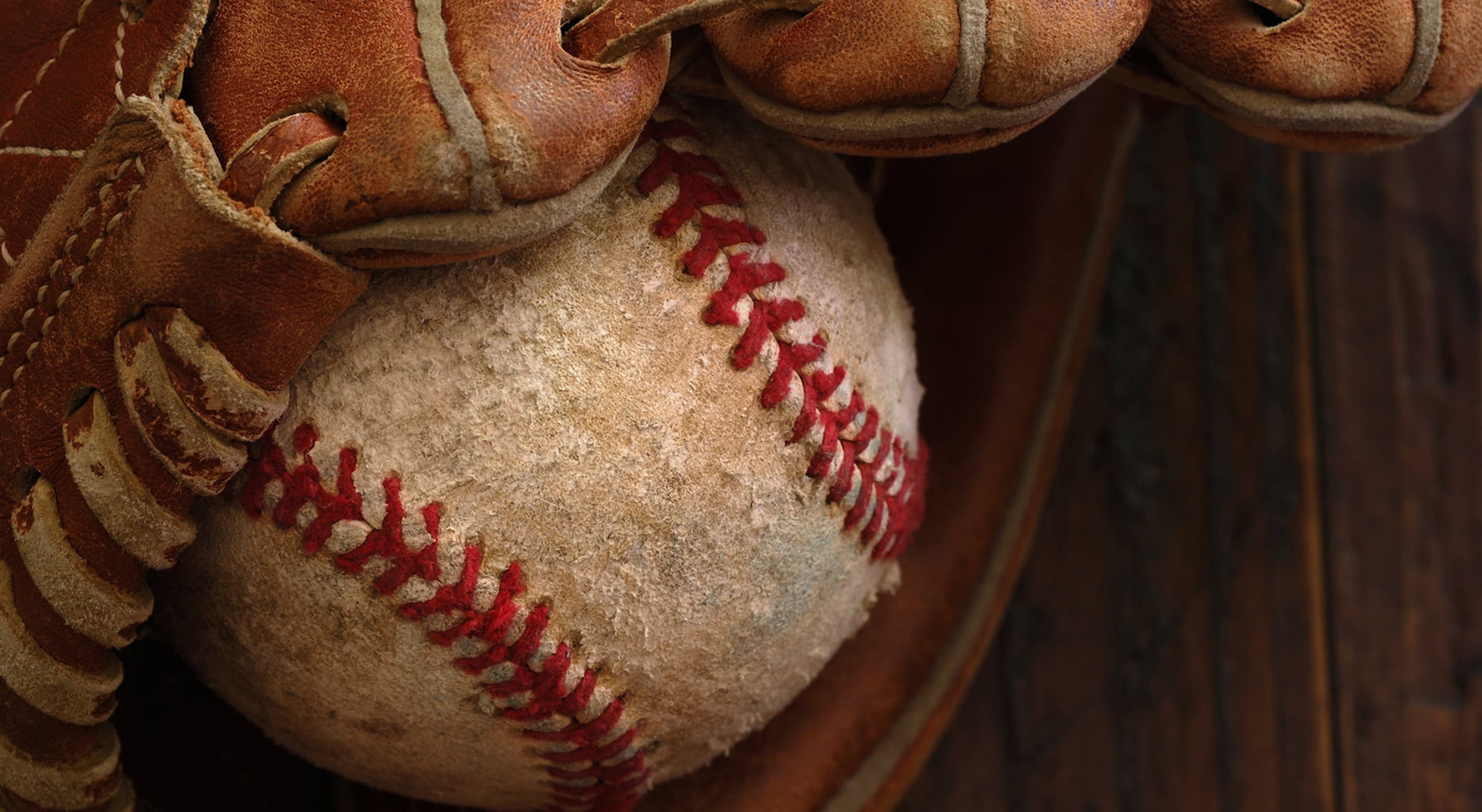 worn baseball in a glove