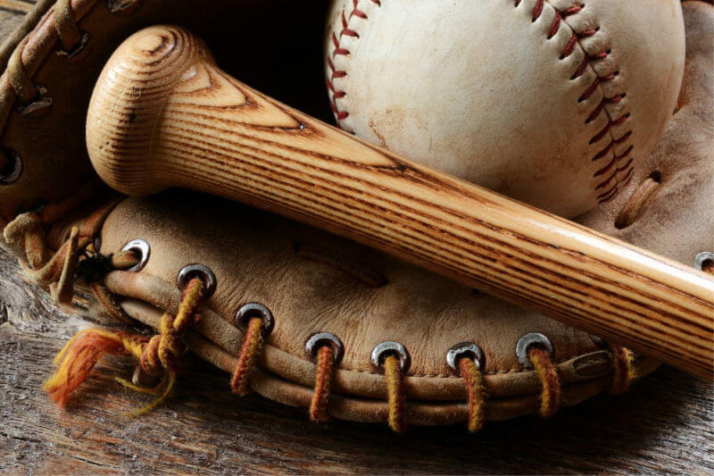 a baseball glove, bat, and ball