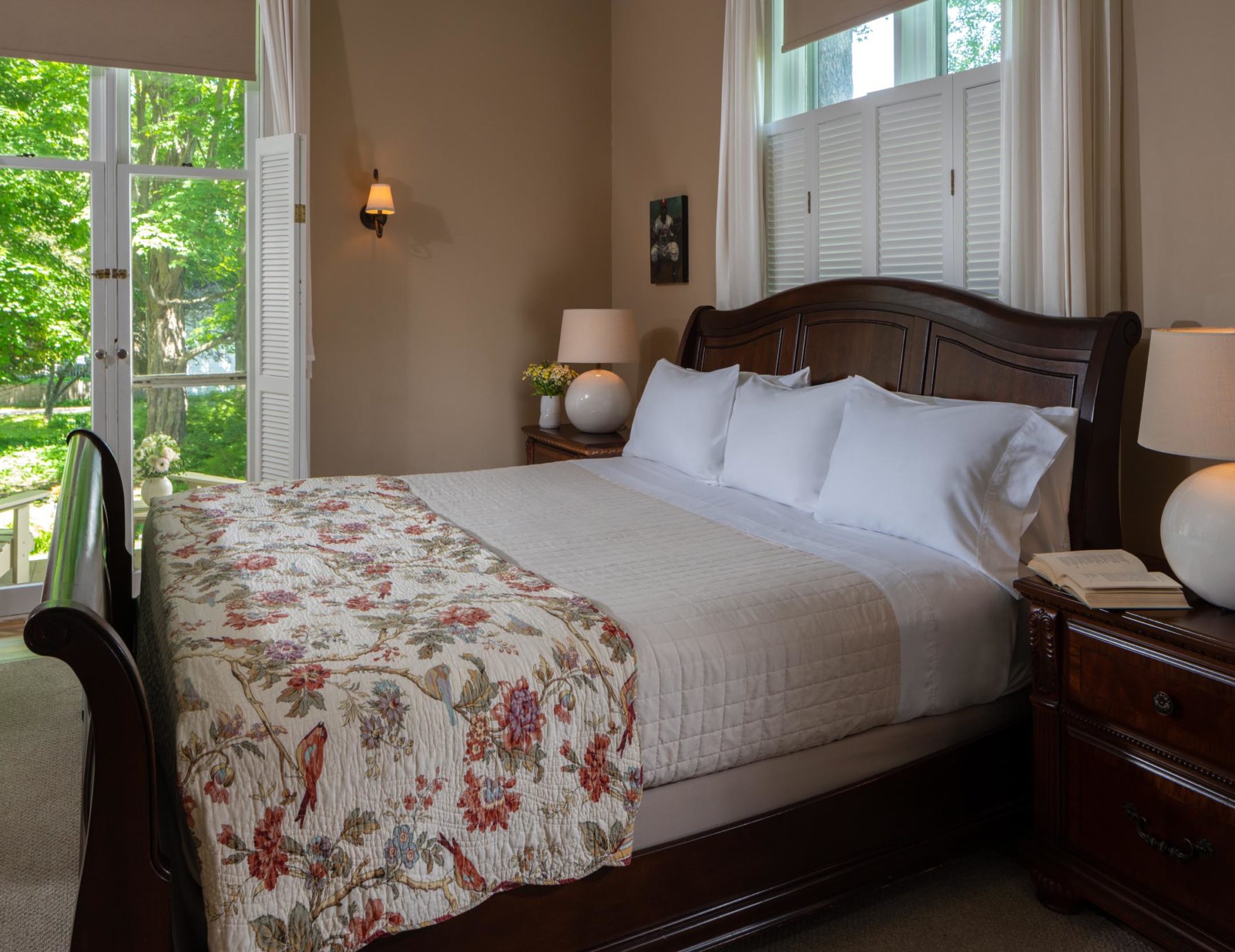 Plush bed by door in the Campanella Room at a Cooperstown Boutique Hotel