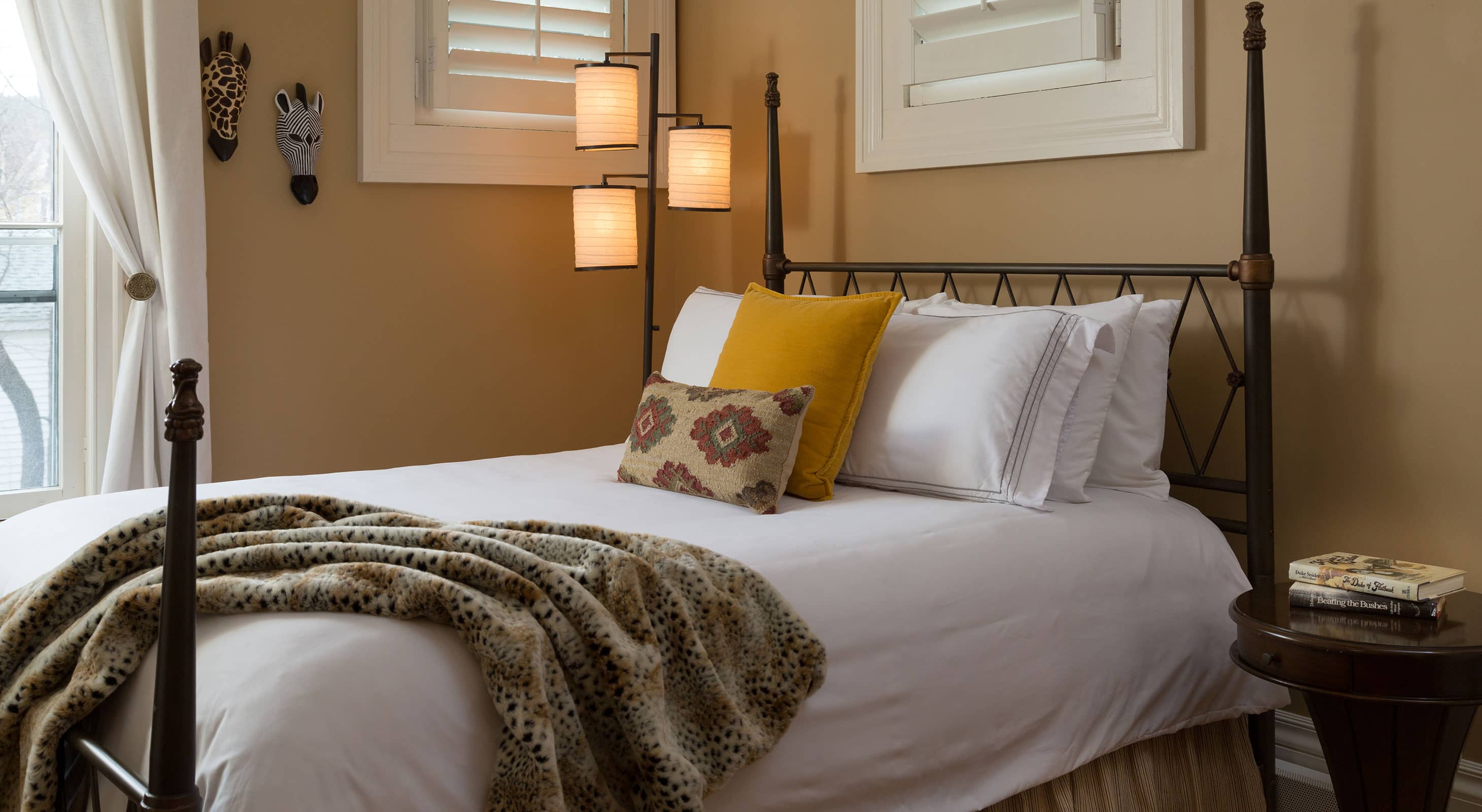 Plush bed with iron-frame headboard