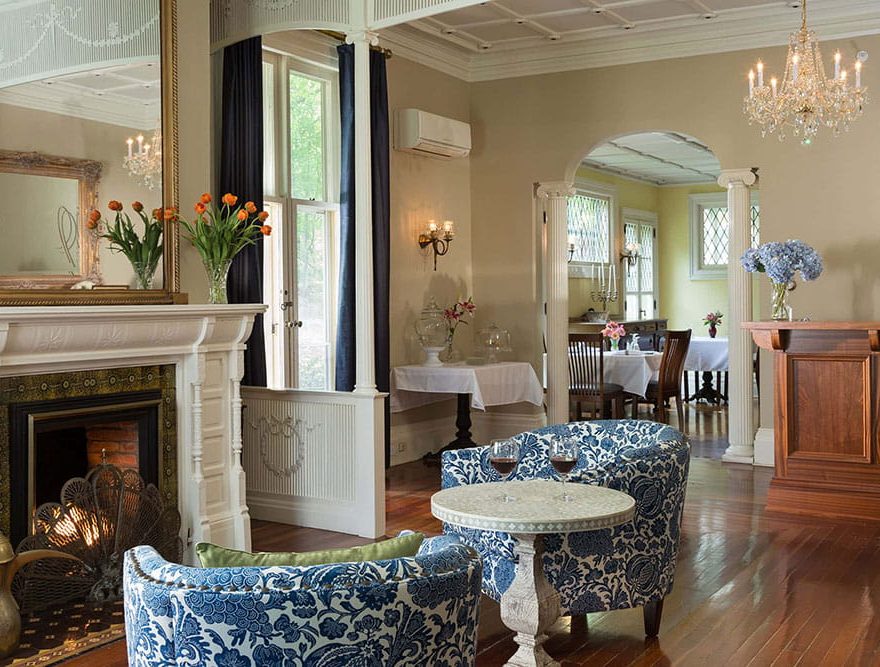 Sitting area with fireplace and chandelier in the Landmark Inn