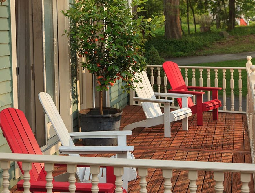 Porch with spaced Adirondack chairs