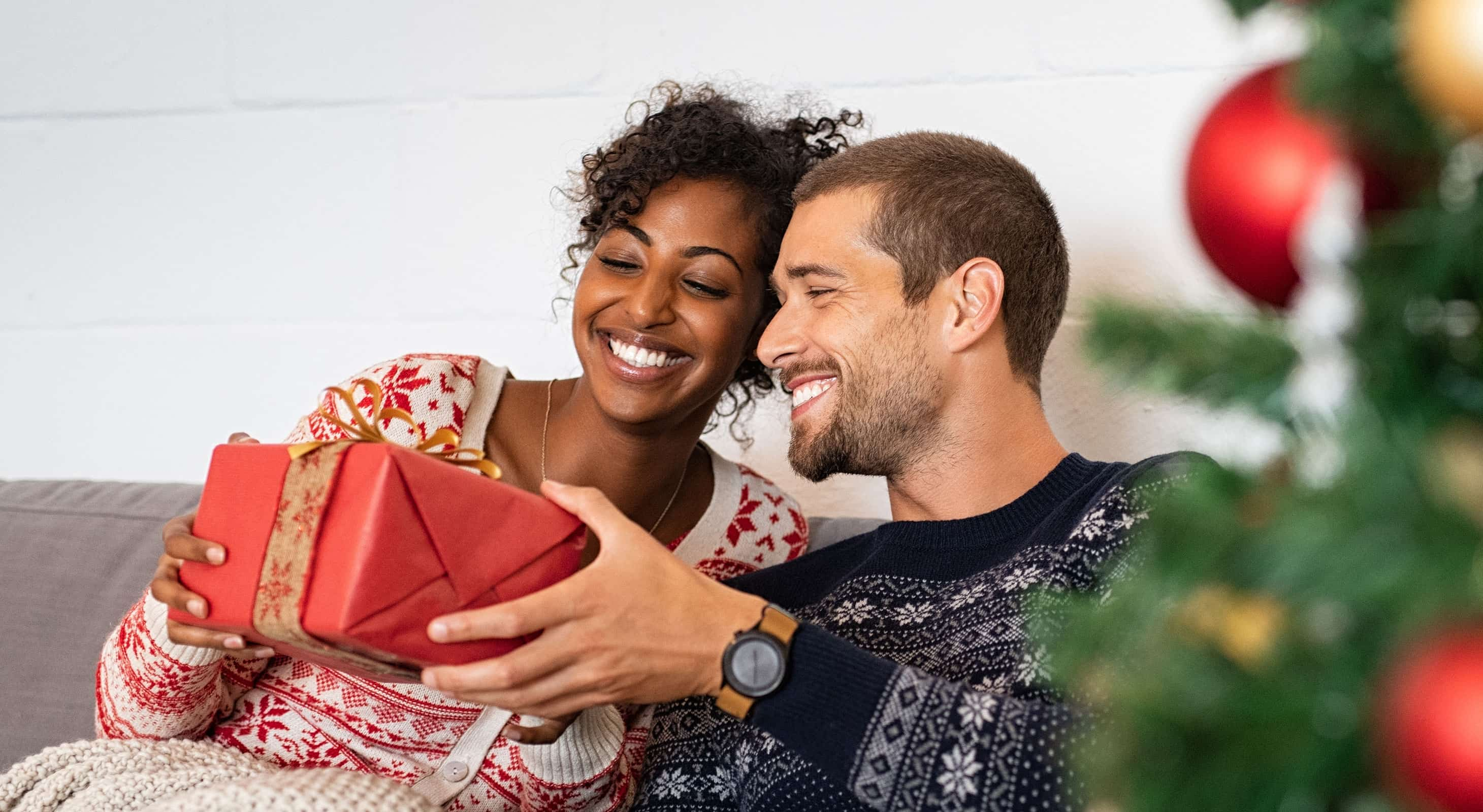 Happy couple opens a Christmas gift together