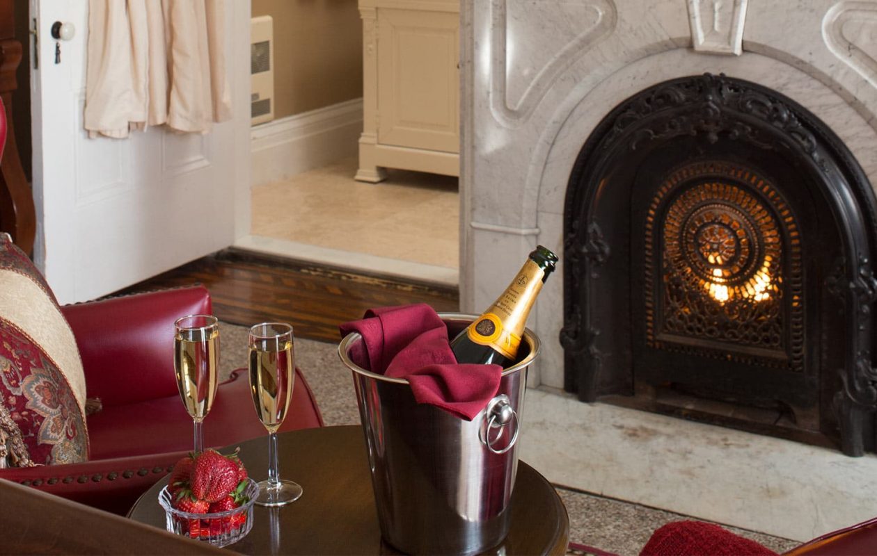 Champagne and Strawberries by a fireplace