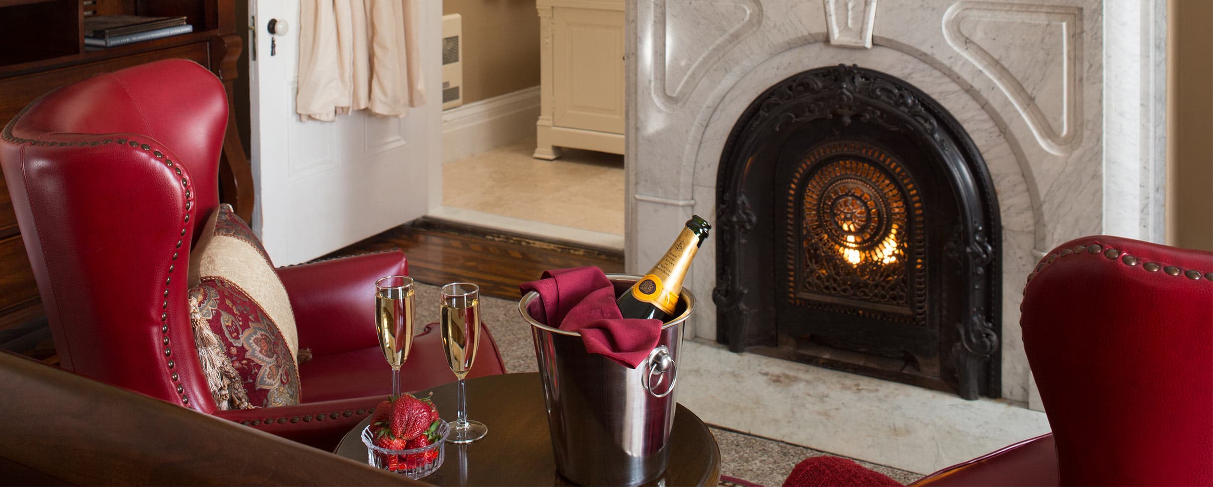 Champagne and Strawberries by a fireplace