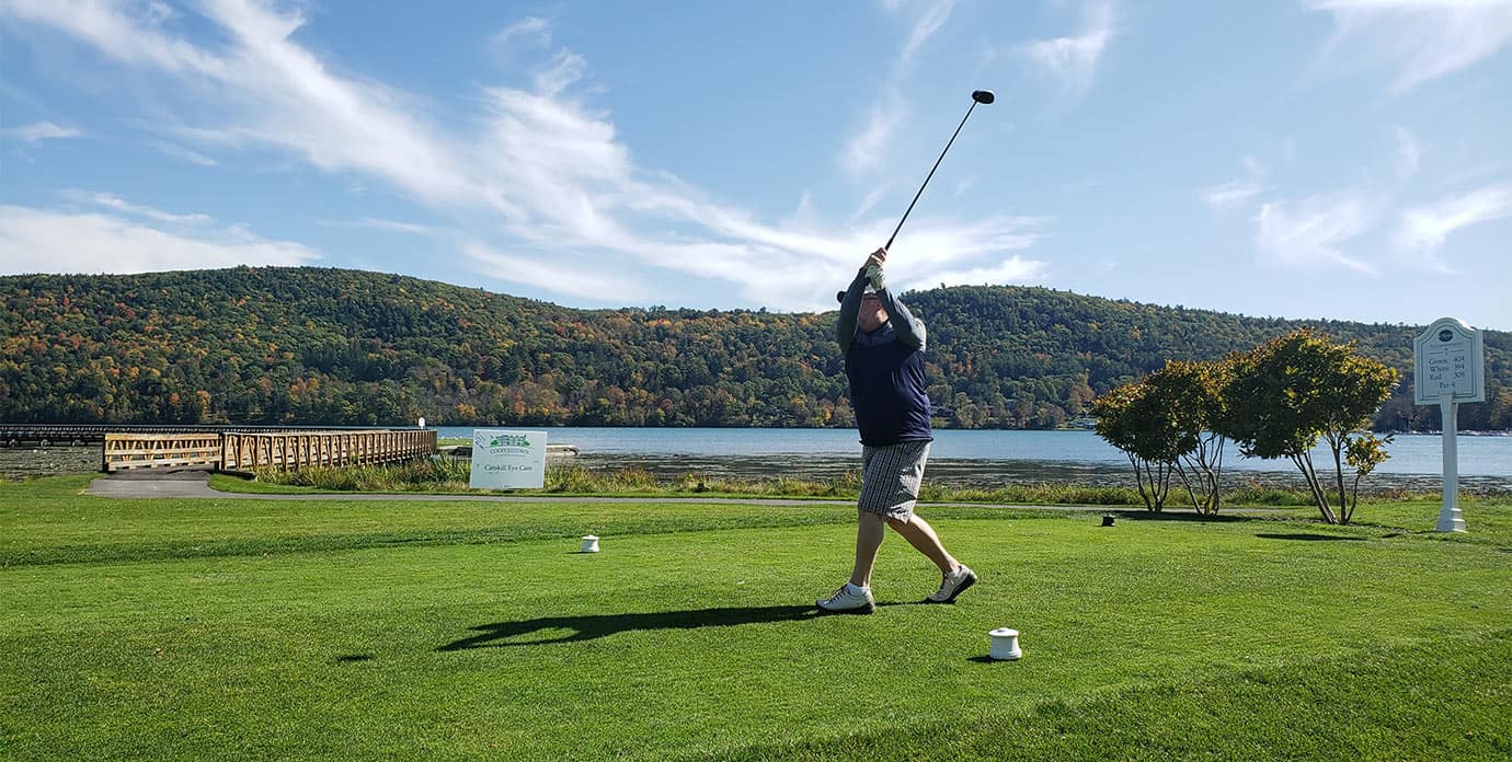 Golfer finishing swing at Leatherstocking Golf Course