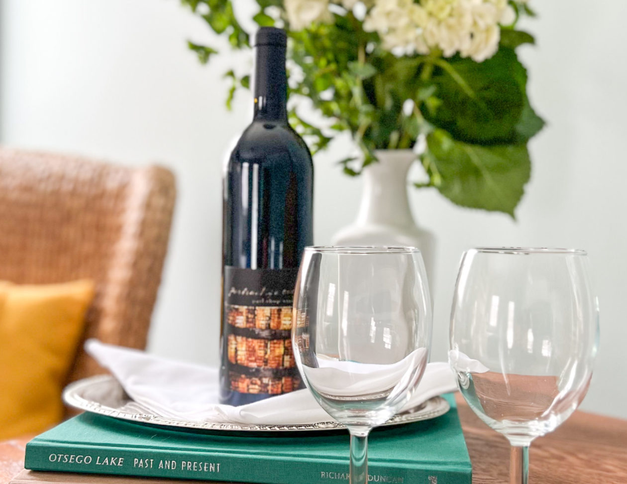 Bottle of wine with glasses outside on a picnic blanket