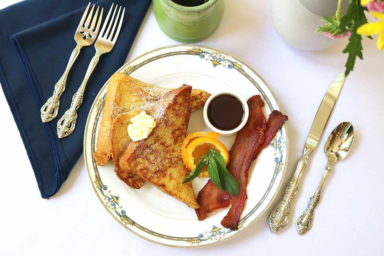 French Toast with fresh orange and a side of bacon