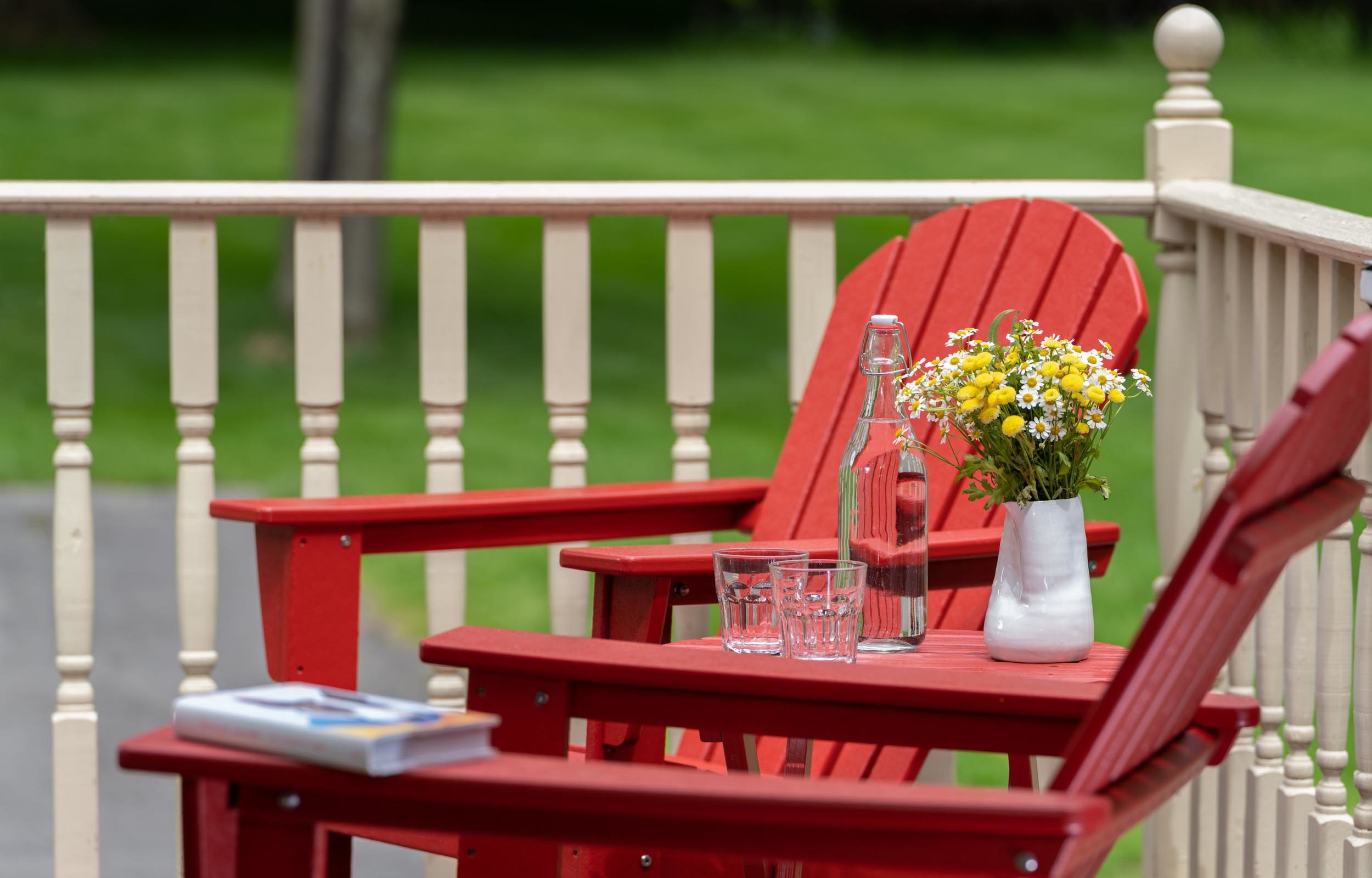 Water with floral arrangement on outdoor table at a Cooperstown Boutique Hotel