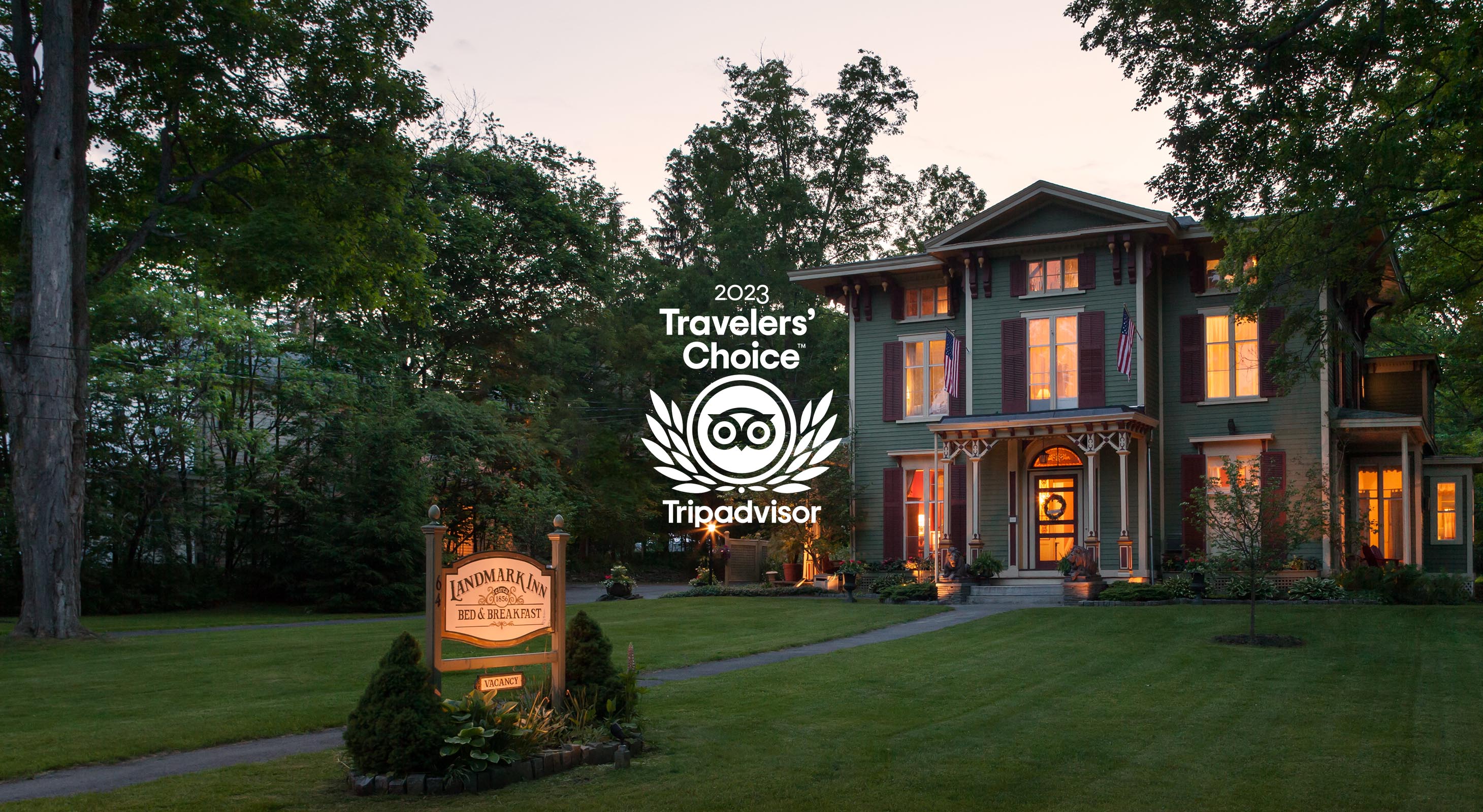 Exterior of inn at dusk with 2020 Travelers Choice logo from TripAdvisor